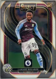 Front of 2024-25 Panini Select Premier League Soccer Lamare Bogarde #112 Mezzanine, portrait-oriented soccer card front featuring Lamarre Bogarde in an Aston Villa kit, centered over a stadium/action background. The top has a large…