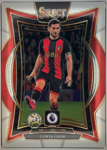 Front of 2024-25 Panini Select Premier League Soccer Lewis Cook #64 Terrace, upright portrait soccer card featuring Lewis Cook in an AFC Bournemouth red-and-black kit, shown running with a ball. The top has a large SELECT…