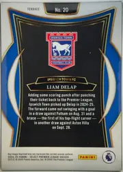 Back of 2024-25 Panini Select Premier League Soccer LIAM DELAP #20, upright card back. A white border surrounds a dark black central panel framed by blue and gold curved ornamental bands. The Ipswich Town crest is…