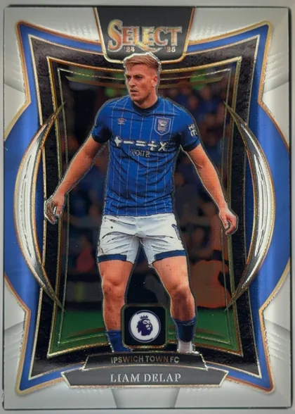 Front of 2024-25 Panini Select Premier League Soccer Liam Delap #20 Terrace, front-facing portrait soccer card. A large Liam Delap action photograph occupies the center, showing him in a blue Ipswich Town FC kit. The top has…