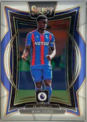 Front of 2024-25 Panini Select Premier League Soccer Marc Guéhi #78 Terrace, front of a portrait soccer card. A Crystal Palace player is shown standing in uniform against a dark stadium background. The SELECT 24/25 logo is…