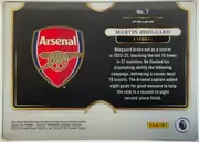Back of 2024-25 Panini Select Premier League Soccer Martin Ødegaard #7 Silver Prizm, landscape-oriented card back. A large Arsenal crest occupies the left half of a black panel. On the right, a white rounded nameplate reads "MARTIN…