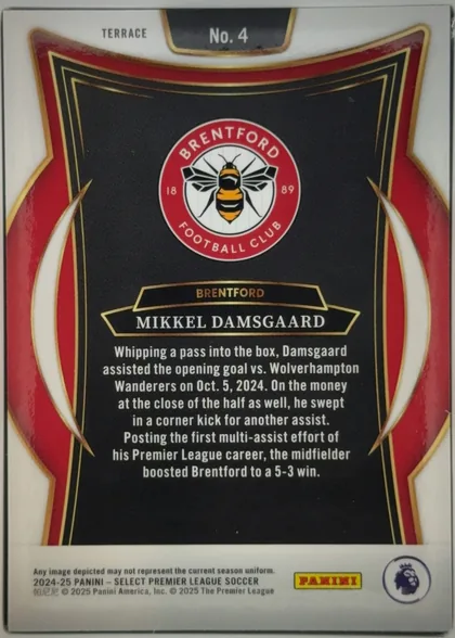 Back of 2024-25 Panini Select Premier League Soccer Mikkel Damsgaard #4 Terrace, upright portrait-format card back. A white border surrounds a red, black, gold, and white decorative frame. The upper area shows TERRACE at left and…