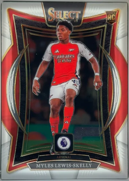 Front of 2024-25 Panini Select Premier League Soccer Myles Lewis-Skelly #31 Rookie Card, front-facing portrait soccer card. A full-body image of Myles Lewis-Skelly in an Arsenal red-and-white kit is centered within an ornate black, red…