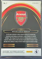 Back of 2024-25 Panini Select Premier League Soccer MYLES LEWIS-SKELLY #7 Silver Prizm, portrait-oriented card back with a white top and bottom panel surrounding a dark charcoal central field. The Arsenal crest is centered near the top…