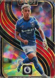 Front of 2024-25 Panini Select Premier League Soccer Omari Hutchinson #120 Mezzanine Prizm, portrait soccer card front. A full-body action image of Omar Hutchinson in a blue kit is centered over a vivid multicolored geometric foil…