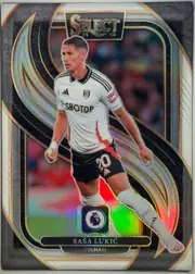 Front of 2024-25 Panini Select Premier League Soccer SAŠA LUKIĆ #123 Mezzanine Prizm, upright portrait soccer card front. A full-body image of Saša Lukić in a white Fulham kit dominates the center. The SELECT logo is printed in a…