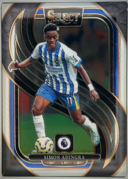 Front of 2024-25 Panini Select Premier League Soccer Simon Adingra #139 Mezzanine, portrait soccer card front. A full-body action image of Simon Adingra in a blue-and-white Brighton & Hove Albion kit dominates the center. The…