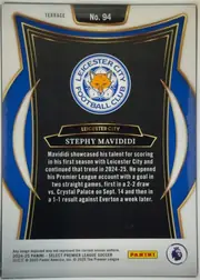 Back of 2024-25 Panini Select Premier League Soccer Stephy Mavididi #94 Rookie Card, portrait-oriented card back. A white upper and lower border surrounds a black central panel framed by layered gold lines and large blue side…