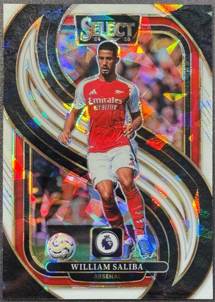 Front of 2024-25 Panini Select Premier League Soccer William Saliba #131 Mezzanine /85, serial numbered 11/85, upright portrait soccer card front. William Saliba is shown running in an Arsenal red-and-white kit. The top has a metallic SELECT title with '24…