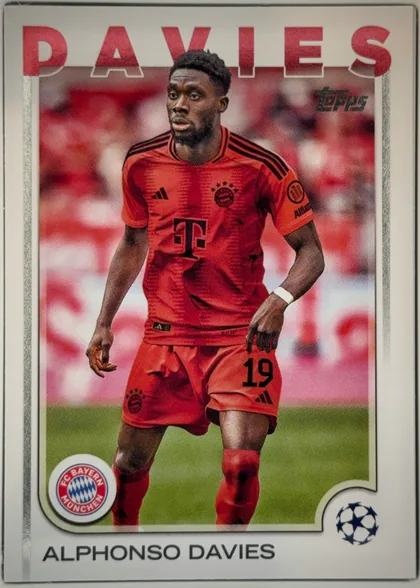 Front of 2024-25 Topps UEFA Club Competitions Soccer Alphonso Davies #96, portrait soccer card oriented upright. A Bayern Munich player in a red kit occupies the central action photograph against a blurred red-and-white…