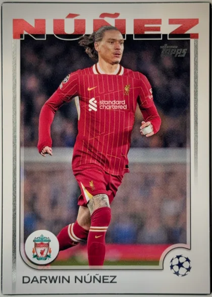 Front of 2024-25 Topps UEFA Club Competitions Soccer Darwin Núñez #89 Base, front of a soccer card. A full-length action photograph of a player in a red Liverpool home kit (red shirt with thin gold vertical pinstripes, white…