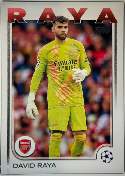Front of 2024-25 Topps UEFA Club Competitions Soccer David Raya #154 Base, portrait soccer card front. A full-body image of David Raya in a bright lime Arsenal goalkeeper uniform occupies the central image area, with a…