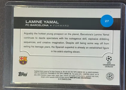 Back of 2024-25 Topps UEFA Club Competitions Soccer Lamine Yamal #27 Base, landscape-oriented player card back. A black header spans the upper portion with large white LAMINE YAMAL lettering, FC BARCELONA and FORWARD…