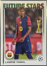 Front of 2024-25 Topps UEFA Club Competitions Soccer Lamine Yamal #27 Base, front of a soccer card. A bold sans-serif 'FUTURE STARS' title in a green-to-brown metallic gradient spans the top. The central photograph shows a…