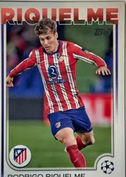 Front of 2024-25 Topps UEFA Club Competitions Soccer Rodrigo Riquelme #37 Base, front of a soccer card. Across the top, the surname 'RIQUELME' is printed in large red capital letters with a white outline, partly overlapped by…