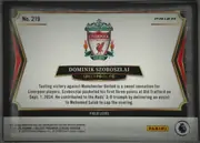 Back of 2024 Panini Select Premier League Dominik Szoboszlai #219 Prizm; Field Level, landscape-oriented soccer card back. A large Liverpool Football Club crest is centered near the top. The card number "No. 219" appears at upper-left…