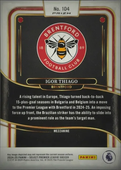 Back of 2024 Panini Select Premier League Igor Thiago #104 Mezzanine, upright portrait-oriented card back. A white tab at the top reads "No. 104" with the PRIZM logo below. The upper black panel contains the red…