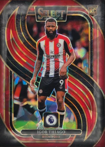 Front of 2024 Panini Select Premier League Soccer Cards Igor Thiago #104 Mezzanine, upright portrait soccer card. A full-body player in a red-and-white Brentford kit is centered over a blurred stadium background. The large SELECT…