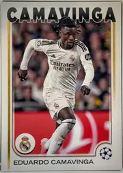 Front of 2024 Topps UEFA Eduardo Camavinga #93 Base, portrait soccer card front. A large black CAMAVINGA title spans the top. The central image shows Eduardo Camavinga running in a white Real Madrid…