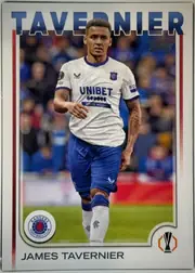 Front of 2024 Topps UEFA James Tavernier #26, portrait-oriented football card front. A large blue TAVERNER heading spans the top above a photograph of James Tavernier in a white Rangers kit with…