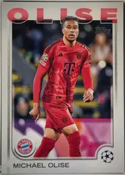 Front of 2024 Topps UEFA Michael Olise #81 Base, front of a soccer card. A large red sans-serif 'OLISE' with white outline spans the top, partly behind the player's head. A dark italic 'topps' logo…