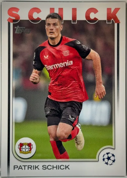 Front of 2024 Topps UEFA Patrik Schick #67, front of a soccer trading card. A full-bleed action photograph shows a player in a red-and-black Bayer Leverkusen home kit (white 'Barmenia' chest…