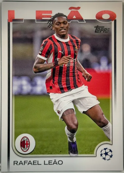 Front of 2024 Topps UEFA Rafael Leão #11 Base, front of a soccer card. A full-length action photograph of a player in an AC Milan red-and-black vertically striped jersey with white shorts and…