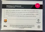 Back of 2024 Topps UEFA Ronald Araújo #24 Base, back side oriented upright. A black header band near the top contains the large white name RONALD ARAÚJO, the team FC BARCELONA, position DEFENDER…