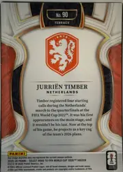Back of 2025-26 Panini - Select Road to FIFA World Cup 2026 Soccer Jurrien Timber #90 Terrace, back side upright in portrait orientation. The top center has a black textured panel with a gold outline containing "No. 90" and "TERRACE". A…
