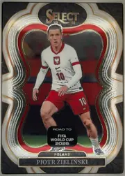 Front of 2025-26 Panini - Select Road to FIFA World Cup 2026 Soccer Piotr Zielinski #138 Mezzanine, portrait-oriented soccer card front, upright at 0°. Top center shows the gold "SELECT" wordmark inside a dark oval with "'25" and "'26" flanking it…