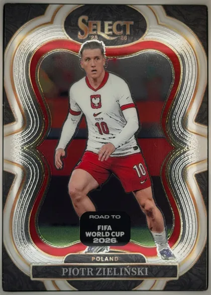 Front of 2025-26 Panini - Select Road to FIFA World Cup 2026 Soccer Piotr Zielinski #138 Mezzanine, portrait-oriented soccer card front, upright at 0°. Top center shows the gold "SELECT" wordmark inside a dark oval with "'25" and "'26" flanking it…
