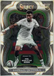 Front of 2025-26 Panini - Select Road to FIFA World Cup 2026 Soccer Raphael Onyedika #122 Mezzanine, front of a portrait soccer card. A full-body image of Raphael Onyedika in a white Nigeria kit occupies the center, with a soccer ball near the lower…