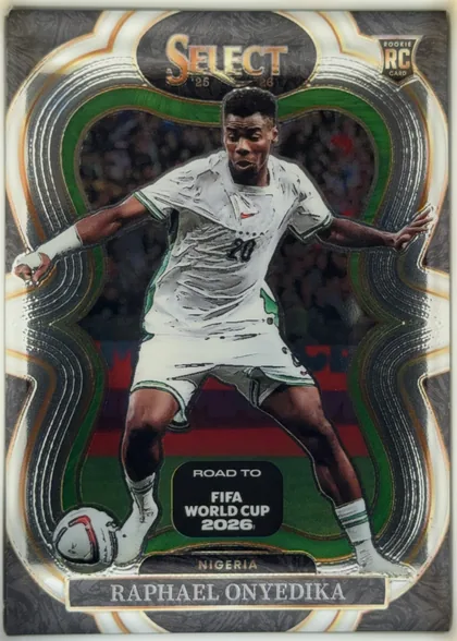 Front of 2025-26 Panini - Select Road to FIFA World Cup 2026 Soccer Raphael Onyedika #122 Mezzanine, front of a portrait soccer card. A full-body image of Raphael Onyedika in a white Nigeria kit occupies the center, with a soccer ball near the lower…