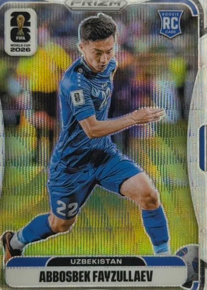 Front of 2026 Panini Prizm FIFA Abbosbek Fayzullaev #448, portrait soccer card front. A player in a blue Uzbekistan kit is shown running with a ball against a colorful stadium background with a reflective…