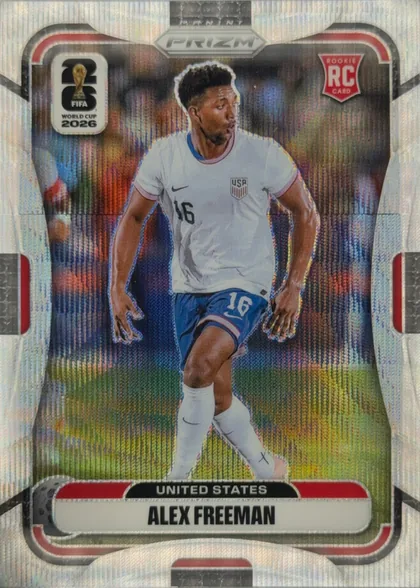 Front of 2026 Panini Prizm FIFA Alex Freeman #433 Base, upright portrait soccer card. A player in a white United States jersey numbered 16 is shown against a reflective multicolor stadium-like background…