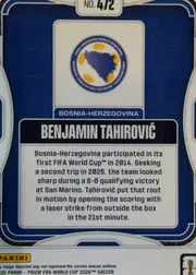 Back of 2026 Panini Prizm FIFA Benjamin Tahirovic #472 Base, landscape-oriented card back with a dark blue background and white rounded border decorations. A Bosnia-Herzegovina crest is centered in the upper…