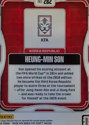 Back of 2026 Panini Prizm FIFA HEUNG-MIN SON #282 Base, upright landscape-oriented card back. A red geometric patterned field is enclosed by white rounded border lines. At the top center is a white label…
