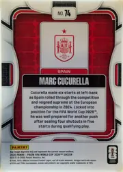 Back of 2026 Panini Prizm FIFA Marc Cucurella #74 Base, portrait-oriented card back with a red repeating geometric background, white rounded outer border, and centered white panel containing the Spain…