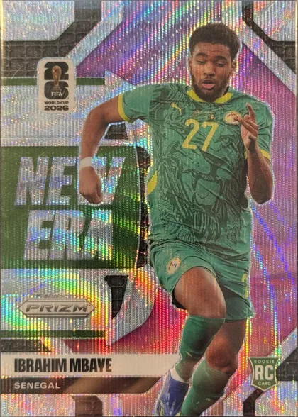 Front of 2026 Panini Prizm FIFA New Era IBRAHIM MBAYE #20, portrait soccer card front showing Ibrahim Mbaye in a green Senegal kit, running with the ball or in motion. A FIFA World Cup 2026 emblem appears in…