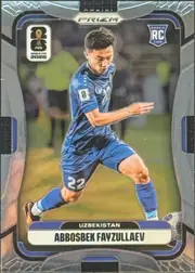 Front of 2026 Panini Prizm FIFA Soccer Cards ABBOSBEK FAYZULLAEV #448 Rookie Card, portrait-format soccer card front. A player in a blue Uzbekistan kit is shown running with a ball partially visible near the lower right. PRIZM is…