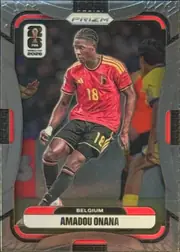 Front of 2026 Panini Prizm FIFA Soccer Cards AMADOU ONANA #163, portrait soccer card front. A player in a red Belgium national-team uniform with number 18 is shown in action against a stadium background. The…