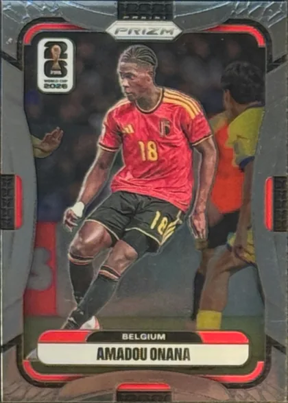 Front of 2026 Panini Prizm FIFA Soccer Cards AMADOU ONANA #163, portrait soccer card front. A player in a red Belgium national-team uniform with number 18 is shown in action against a stadium background. The…