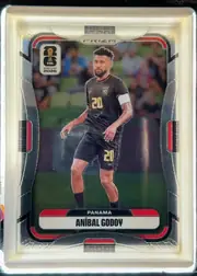 Front of 2026 Panini Prizm FIFA Soccer Cards Aníbal Godoy #337, front of a soccer card. Top center has a silver 'PRIZM' logo tab. Upper left carries a white 'FIFA WORLD CUP 2026' logo with the World Cup trophy…