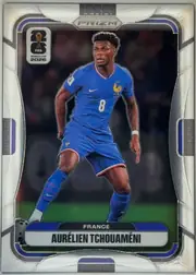 Front of 2026 Panini Prizm FIFA Soccer Cards AURÉLIEN TCHOUAMÉNI #29, portrait soccer card front. A full-body image of Aurélien Tchouaméni in a blue France kit occupies the center against a dark background. The PANINI…