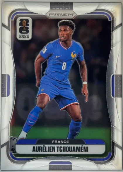 Front of 2026 Panini Prizm FIFA Soccer Cards AURÉLIEN TCHOUAMÉNI #29, portrait soccer card front. A full-body image of Aurélien Tchouaméni in a blue France kit occupies the center against a dark background. The PANINI…