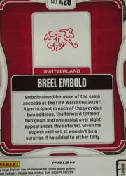Back of 2026 Panini Prizm FIFA Soccer Cards Breel Embolo #420 Prizm refractor, back of a soccer trading card oriented upright. A red patterned field is framed by a white rounded border. Near the top center is a white box…