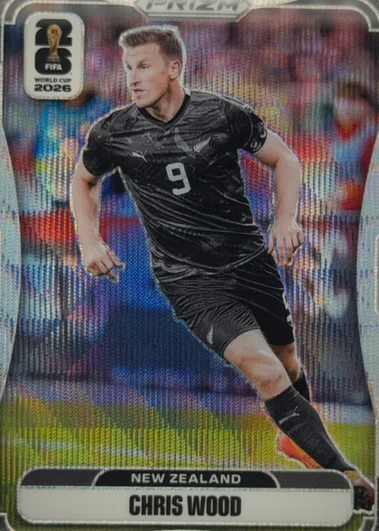 Front of 2026 Panini Prizm FIFA Soccer Cards Chris Wood #320 Prizm refractor (rainbow/holographic), front of a soccer card. A full-body action photo of a male player in a black New Zealand (All Whites) kit with the number 9 on the chest and a…