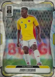 Front of 2026 Panini Prizm FIFA Soccer Cards Jhon Lucumí #184, portrait soccer card front. A player in a yellow Colombia jersey with number 3 is shown on a soccer field. The top center has a PRIZM logo, the…