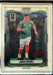 Front of 2026 Panini Prizm FIFA Soccer Cards Johan Vásquez #285 Prizm (base refractor), front side, portrait orientation. A silver/white refractor border with an angular geometric texture and green accent bars frames a dark, blurred…